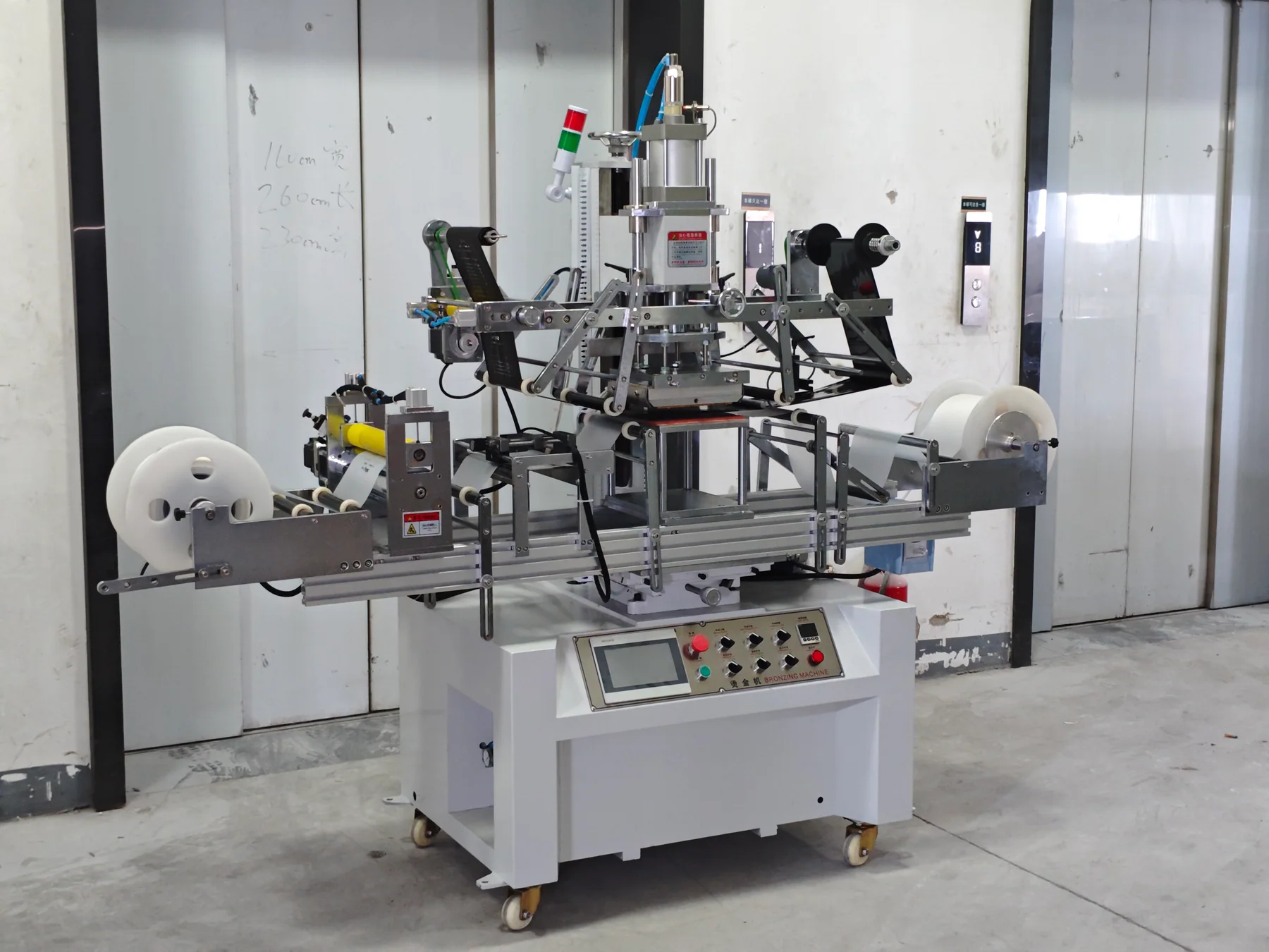 Roll-to-roll flat hot stamping machine with product web and foil paths